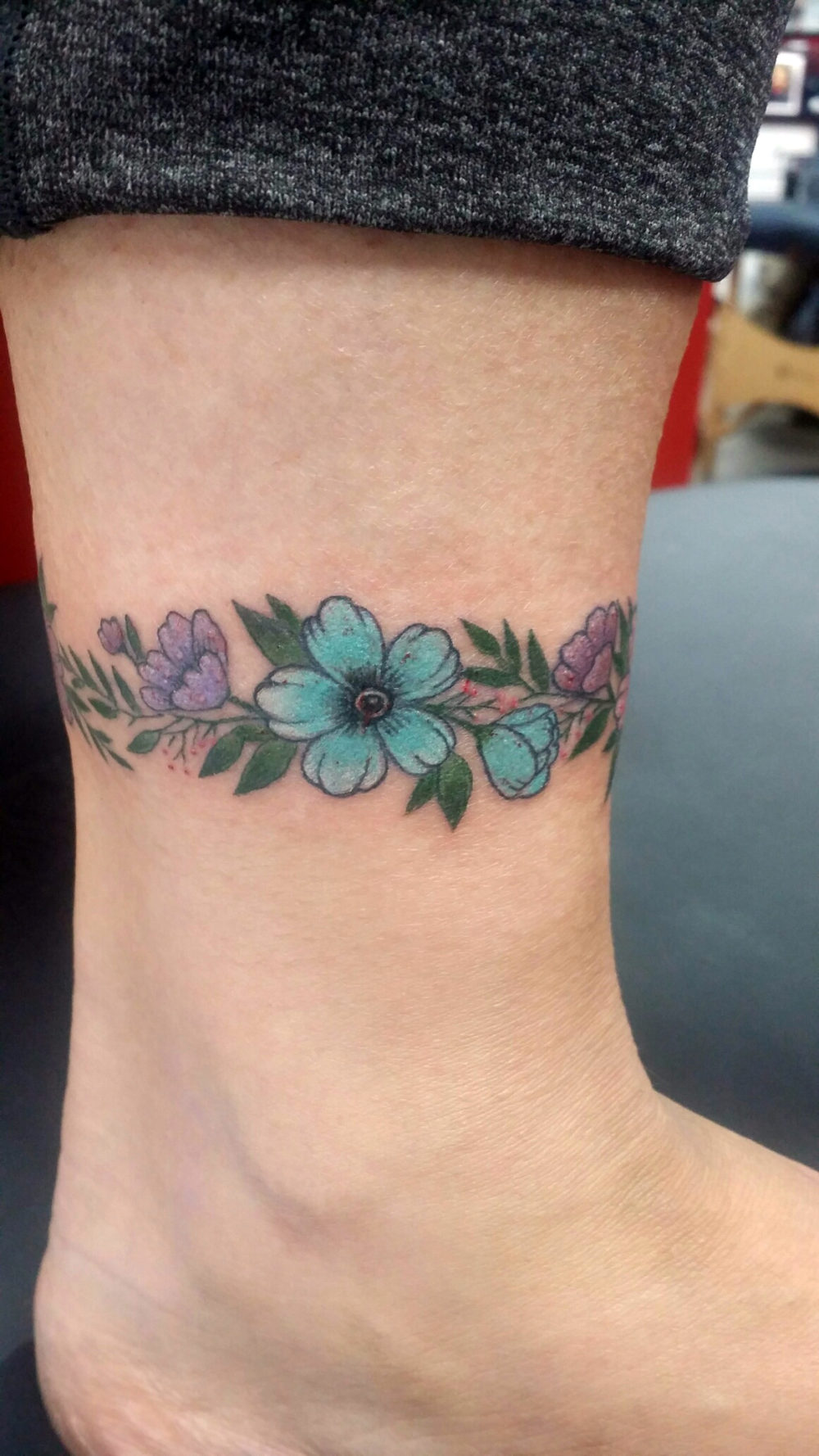 Q Tattoo in Huntington Beach - Karel Beck - Ankle Flowers
