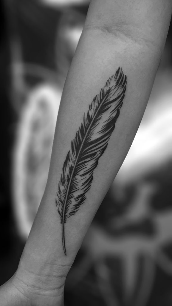 Q Tattoo in Huntington Beach - Sara Delara - feather arm tattoo