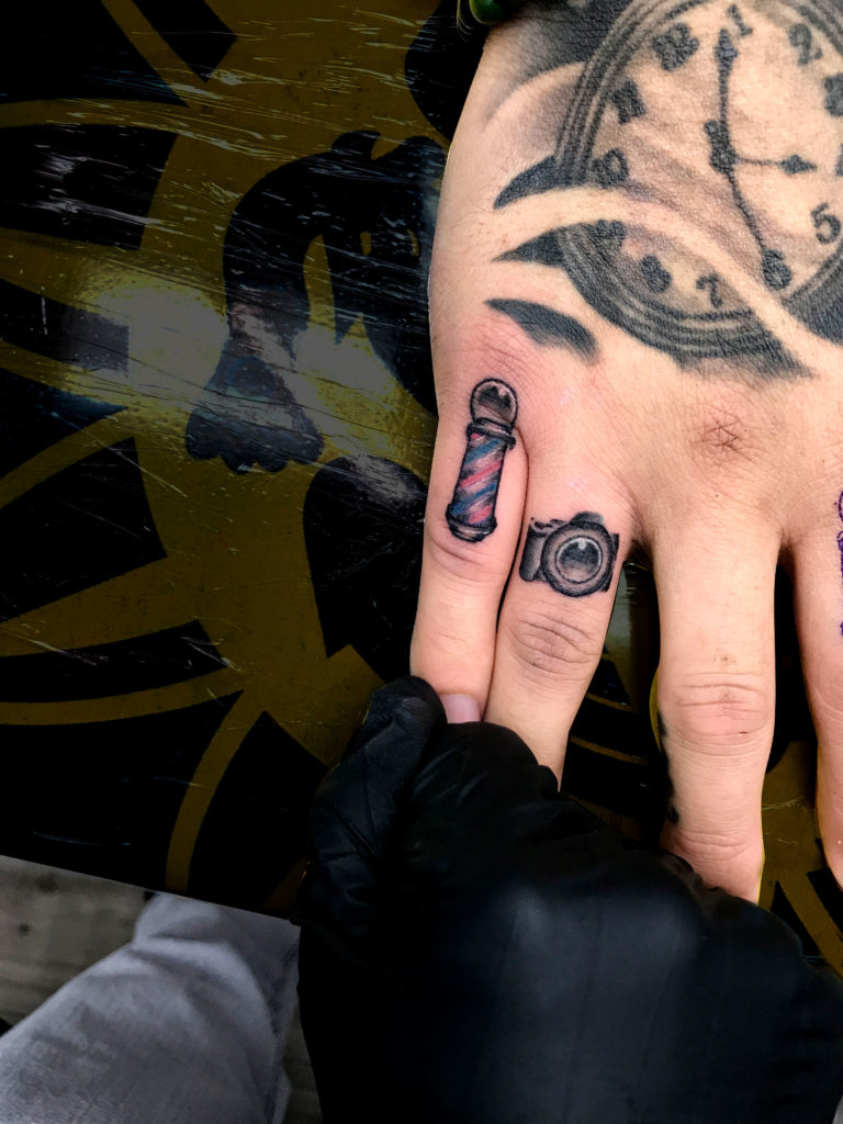 Q Tattoo in Huntington Beach - Sara Delara - small finger tattoos - camera and barber shop